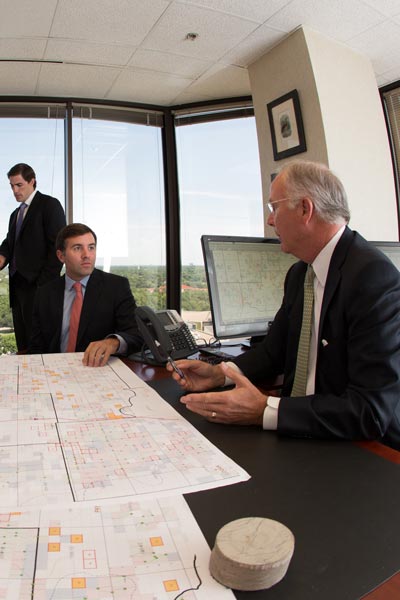 carrollton mineral partners team of oil and gas business men professionals looking at map strategizing